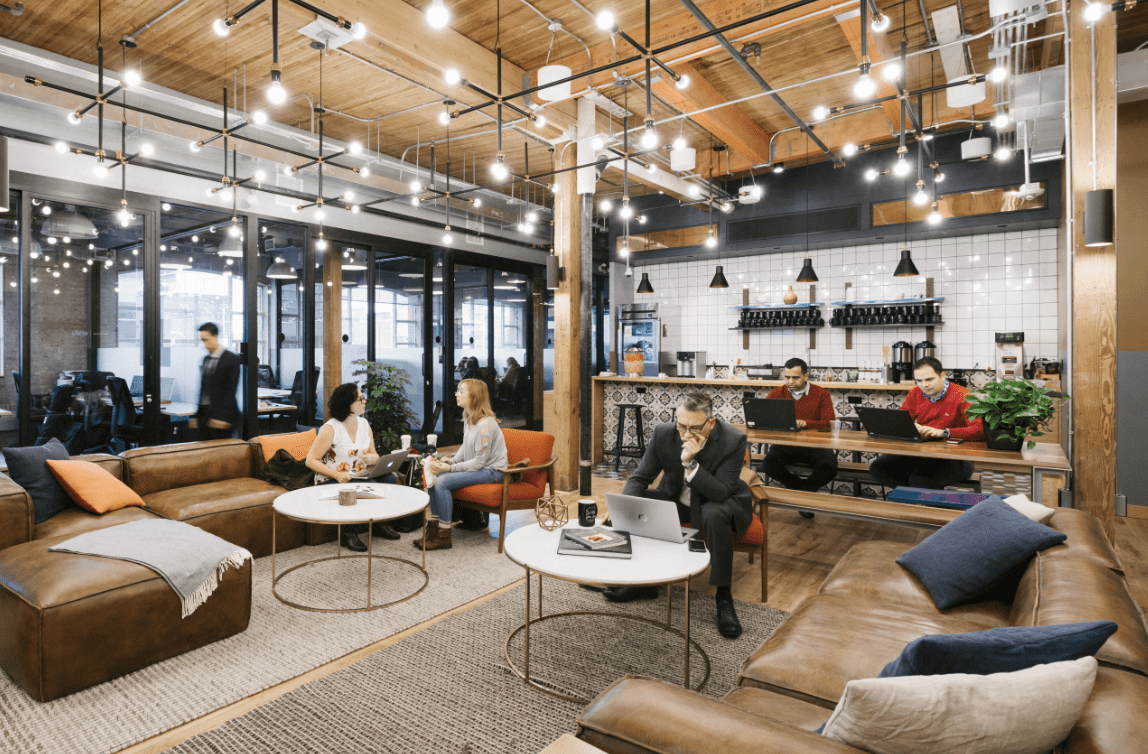 A modern coworking space with people working and socializing.