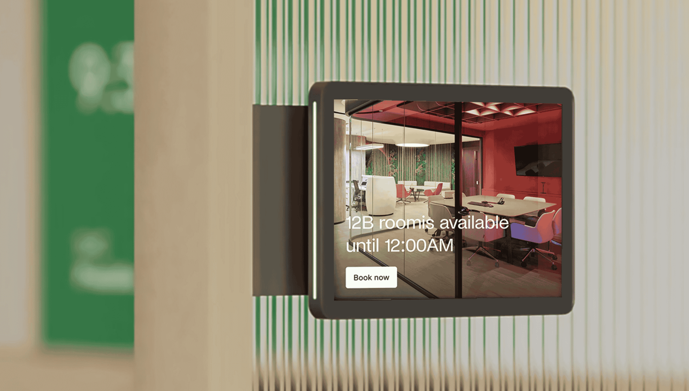 A digital room display panel showing a meeting room's availability and a “Book now” button.