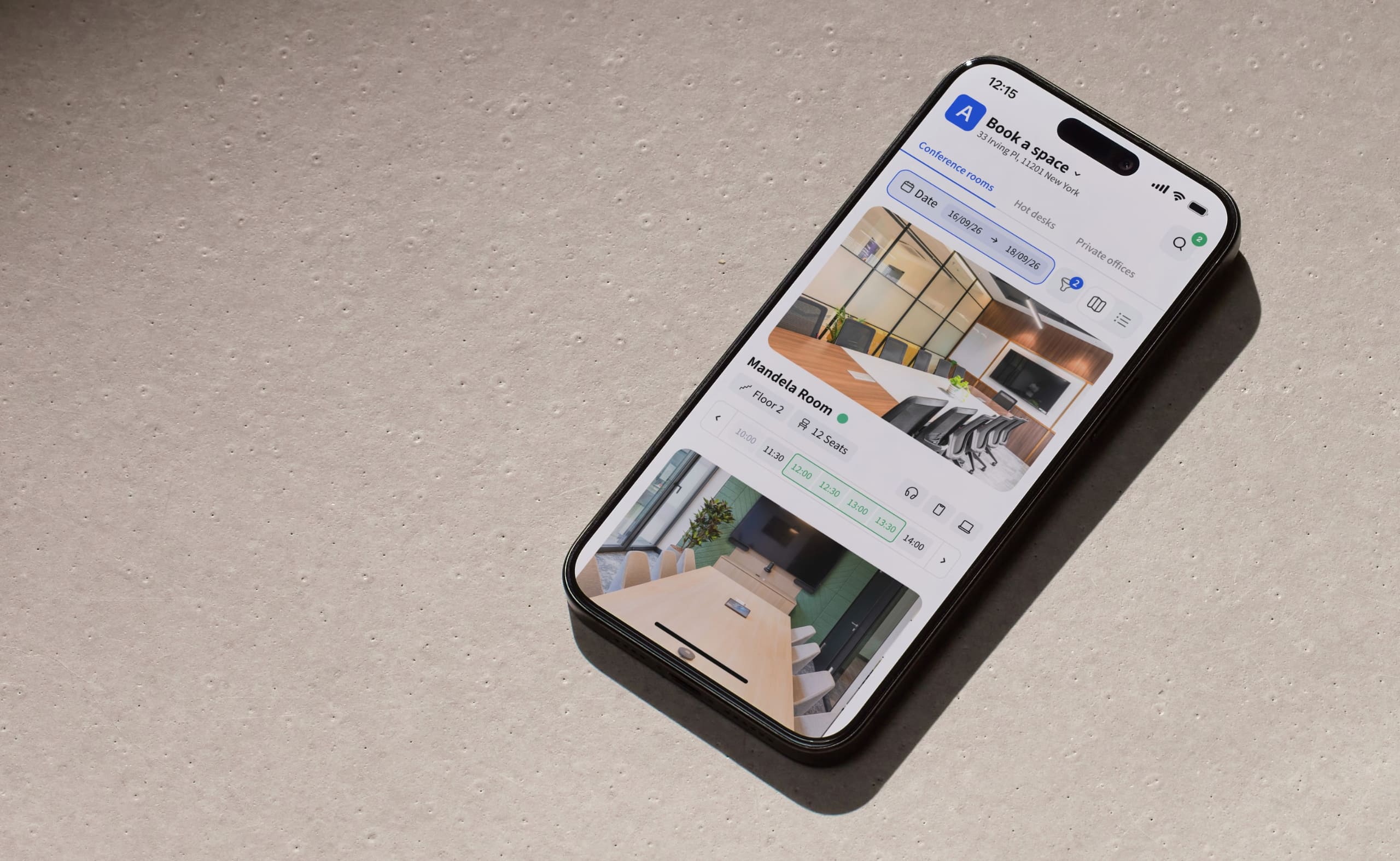 Archie meeting room booking app on a smartphone showing available conference rooms and time slots for reservations.